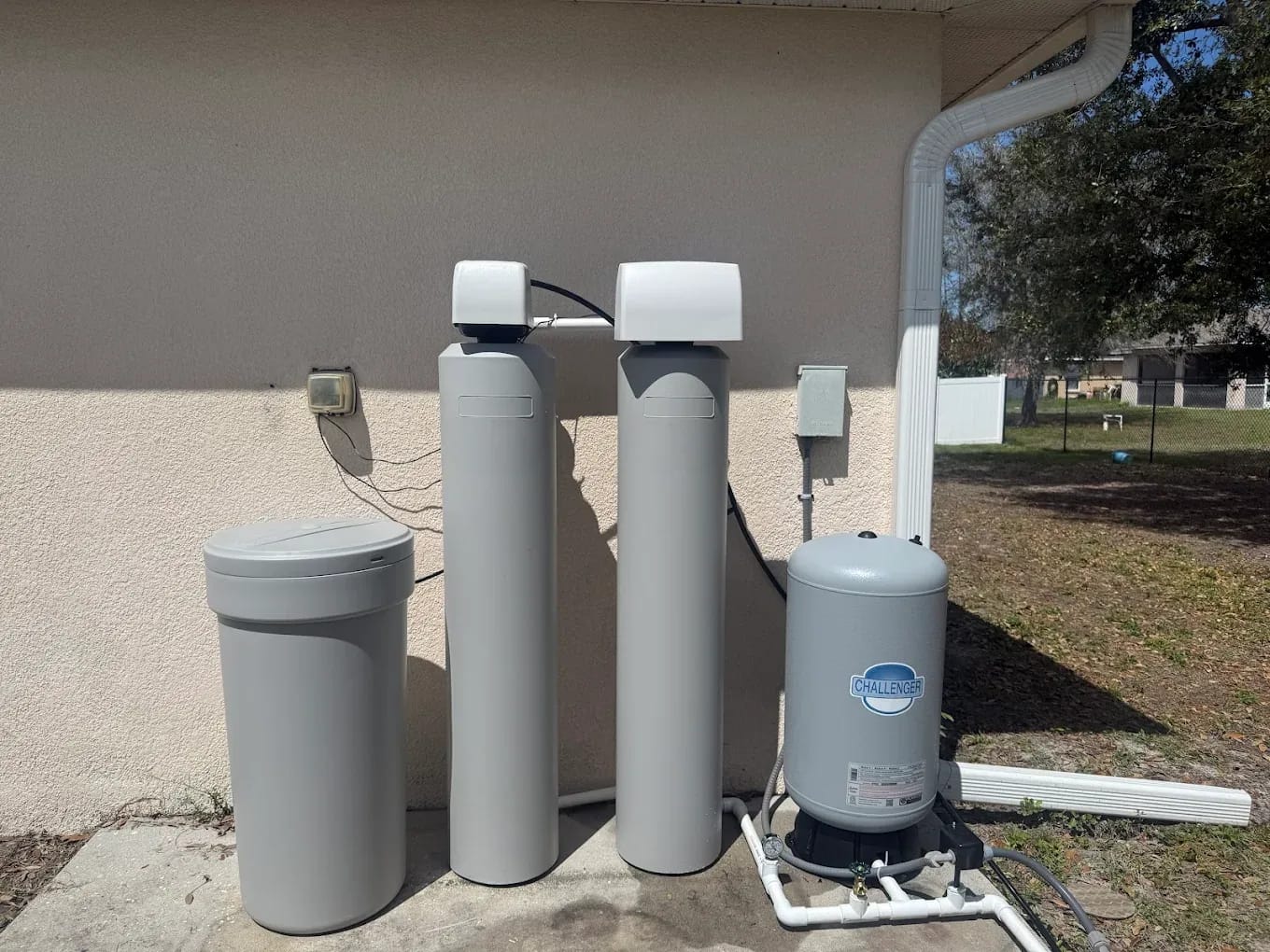 Outdoor well pump and water treatment equipment serviced by Oasis Well Service